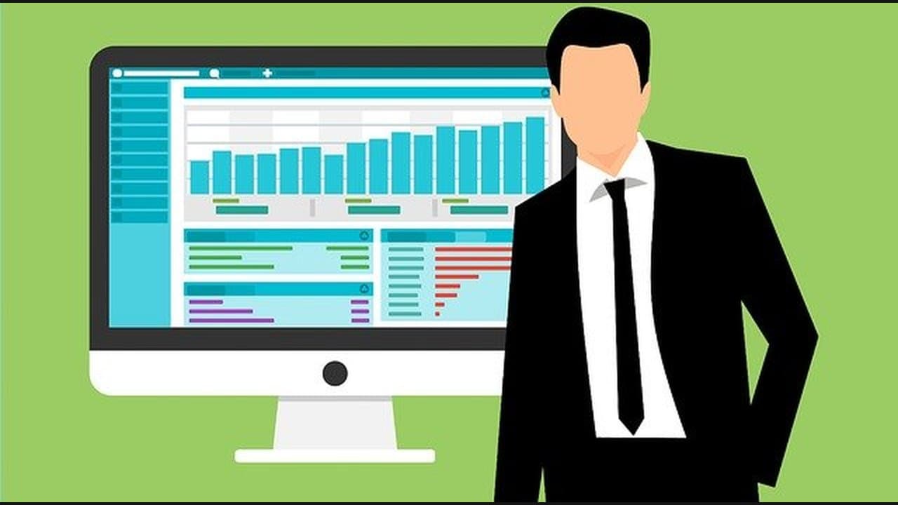 An illustration of a businessman standing beside a monitor showing bar charts and a data table